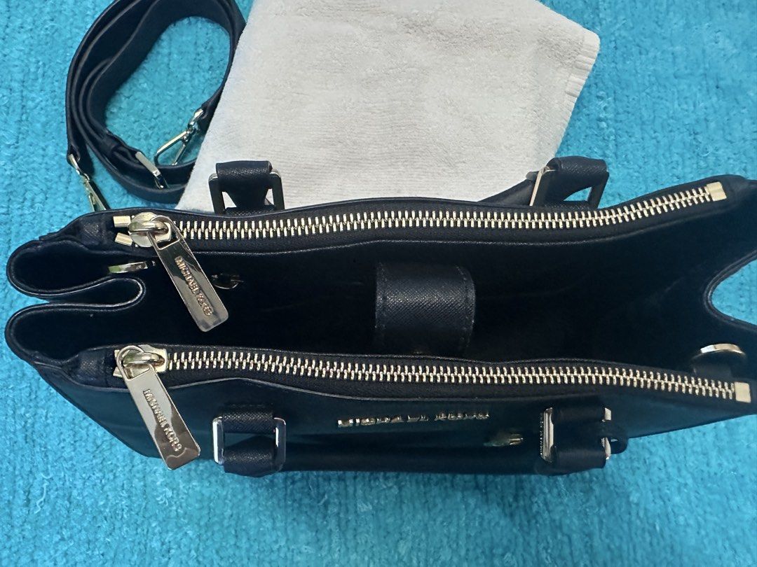 Michael Kors Sutton Black Leather Satchel Handbag (Category: Luxury Bags & Wallets) located in Las Pinas. Submitted by mickey0901 (Listing ID 1441008487, Image 2). Description: - Genuine black leather Michael Kors satchel - Elegant gold hardware details - Versatile carrying options: top handles and detachable crossbody strap - Organized interior with multiple compartments and zip closures - Iconic Michael Kors charm included - Ideal for both dail