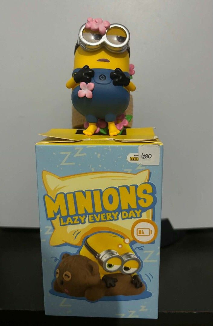 Minions Lazy Every Day Figurine with Box (Category: Designer & Blind Box Toys) located in Makati City. Submitted by yco99 (Listing ID 1441113536, Image 1). Description: - Adorable Minions figurine from the 'Lazy Every Day' series. - Comes with the original box, featuring a resting Minion design. -Opened only, never used or displayed.