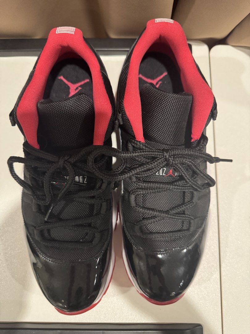 Nike Air Jordan 11 Retro Low (Category: Sneakers) located in Paranaque City. Submitted by consumptionqueen18 (Listing ID 1441069999, Image 3). Description: - Classic Jordan 11 Lows - Black patent leather with red accents - Low-top silhouette - Essential for any sneaker collection.