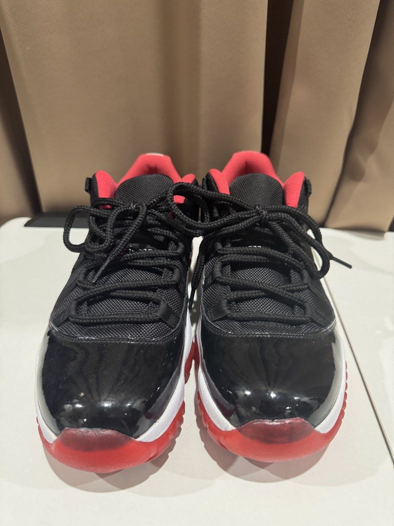 Nike Air Jordan 11 Retro Low (Category: Sneakers) located in Paranaque City. Submitted by consumptionqueen18 (Listing ID 1441069999, Image 2). Description: - Classic Jordan 11 Lows - Black patent leather with red accents - Low-top silhouette - Essential for any sneaker collection.