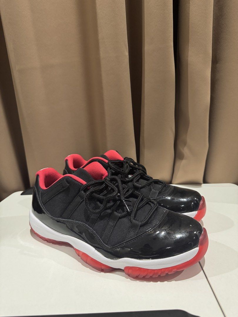 Nike Air Jordan 11 Retro Low (Category: Sneakers) located in Paranaque City. Submitted by consumptionqueen18 (Listing ID 1441069999, Image 1). Description: - Classic Jordan 11 Lows - Black patent leather with red accents - Low-top silhouette - Essential for any sneaker collection.