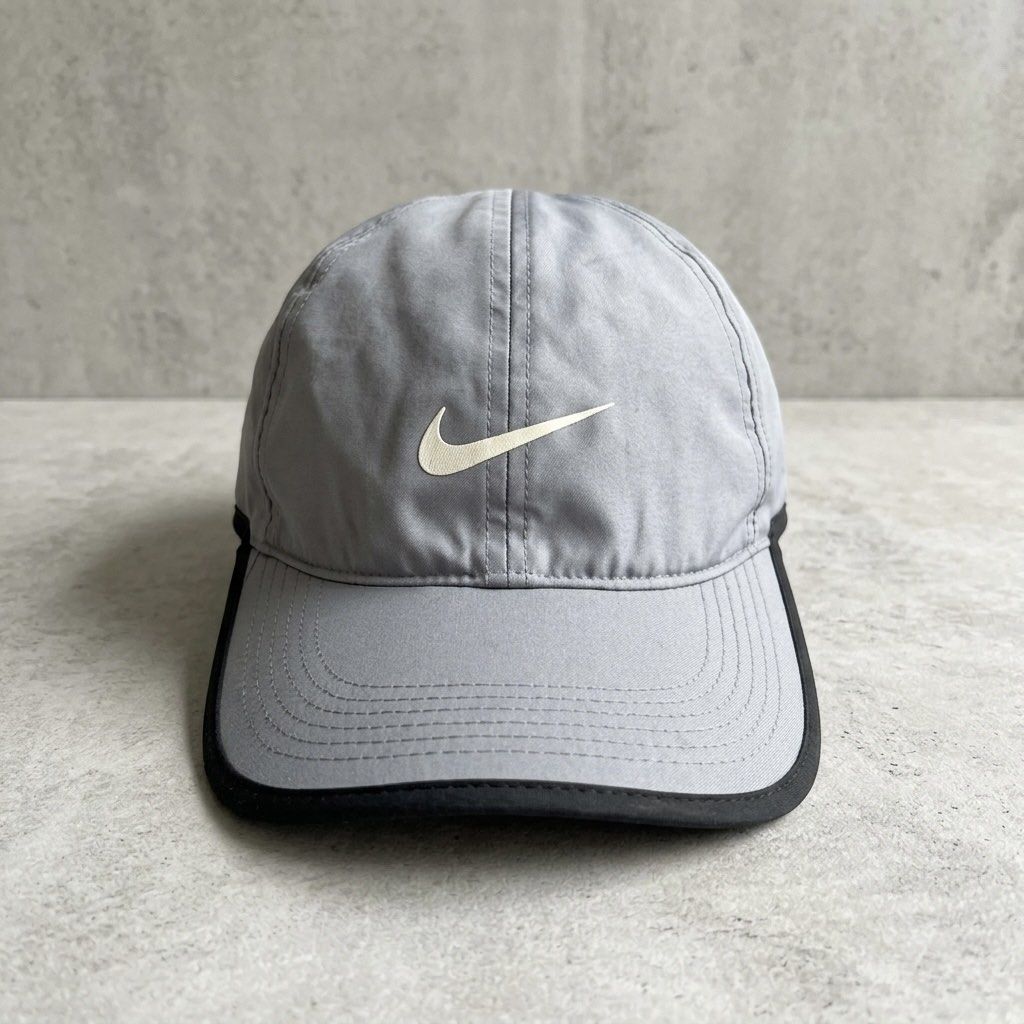 Nike Featherlight Dri-FIT Performance Cap Grey Adjustable Sports Hat (Category: Caps & Hats) located in Paranaque City. Submitted by thepopneverstops (Listing ID 1440920740, Image 1). Description: Condition Rating: 8/10. This cap is in great pre-loved condition, showing only light general signs of wear consistent with regular use. The fabric is clean, and the structure of the crown remains sturdy. It is ready for your next workout or daily run. K