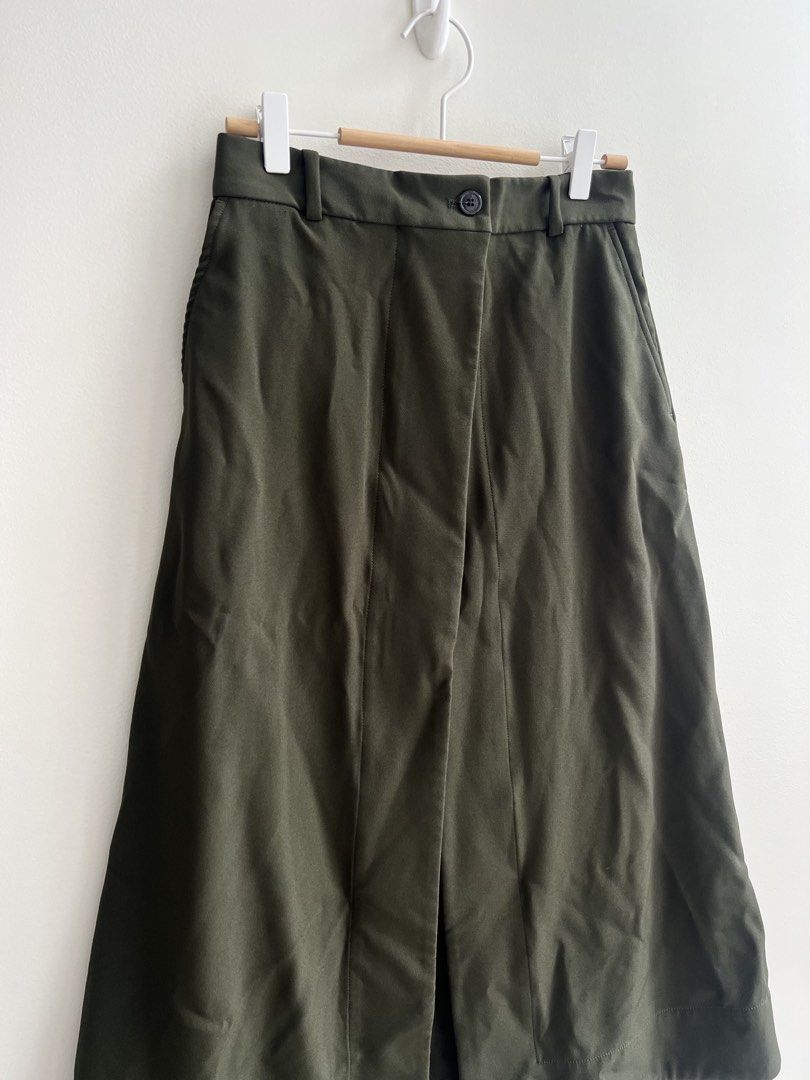 Olive Green Button Front Midi Skirt with Slit (Category: Skirts) located in Paranaque City. Submitted by papermuse (Listing ID 1441034247, Image 2). Description: - Chic tailored olive green midi skirt - Flattering A-line silhouette - Stylish button-front detail - Convenient belt loops - Functional pockets - Fabric with a lovely drape - Versatile for work or casual wear - Effortless to style MOP: BPI / GCash Shipping: Gogoxpress, Grab, Lalamove.