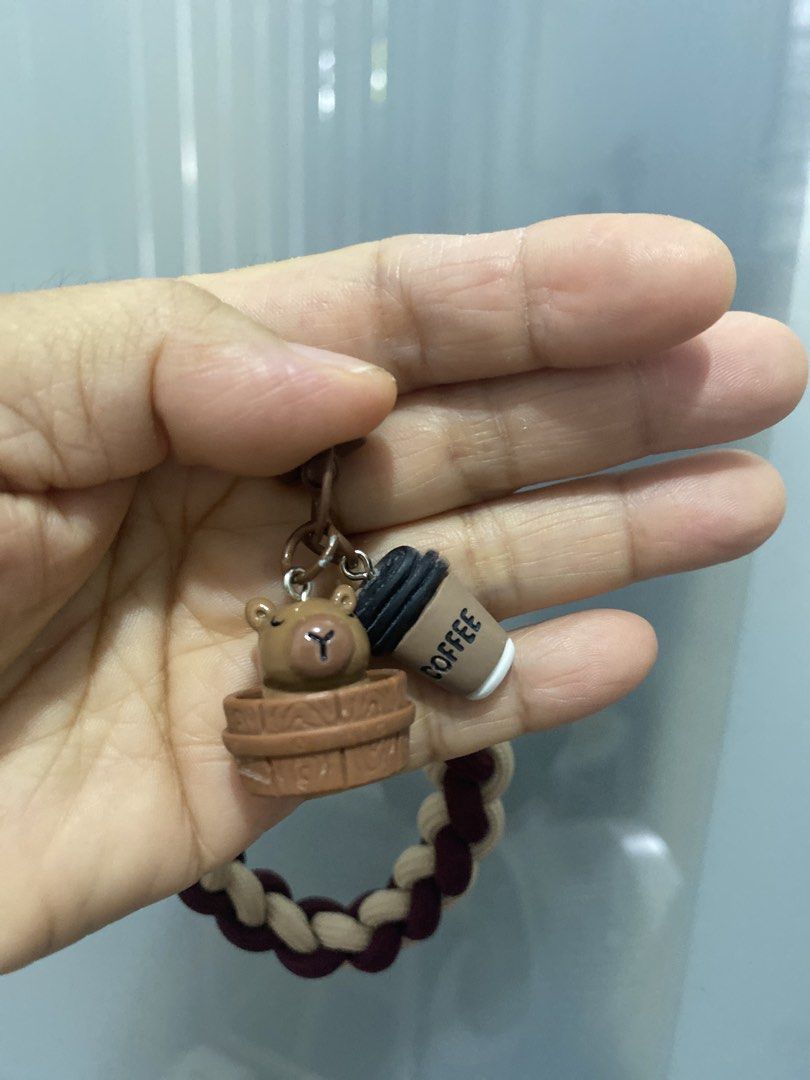Phone Lanyard, Woven Hand Strap Wrist Strap (Category: Handmade Craft) located in Muntinlupa City. Submitted by lay_away_ok (Listing ID 1440957685, Image 2). Description: - Handmade braided keychain - Features cute bear and coffee charms - Maroon and beige braided strap - Sturdy metal clasp for secure attachment - Includes a phone strap attachment - Versatile use: keys, bags, or phone charm - Unique and fun design - Ideal for gifting or personal 