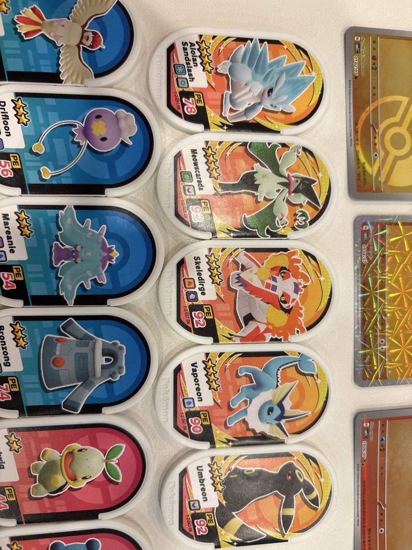 Pokemon Cards and Mezatags (Category: Raw Singles) located in Manila. Submitted by andreiambi74724 (Listing ID 1441049634, Image 3). Description: - Collection of Pokemon battle tokens and cards - Features popular Pokemon like Pikachu, Umbreon, and Vaporeon - Includes holographic cards for added rarity - Tokens display Pokemon characters and battle stats - Perfect for any Pokemon fan or collector.