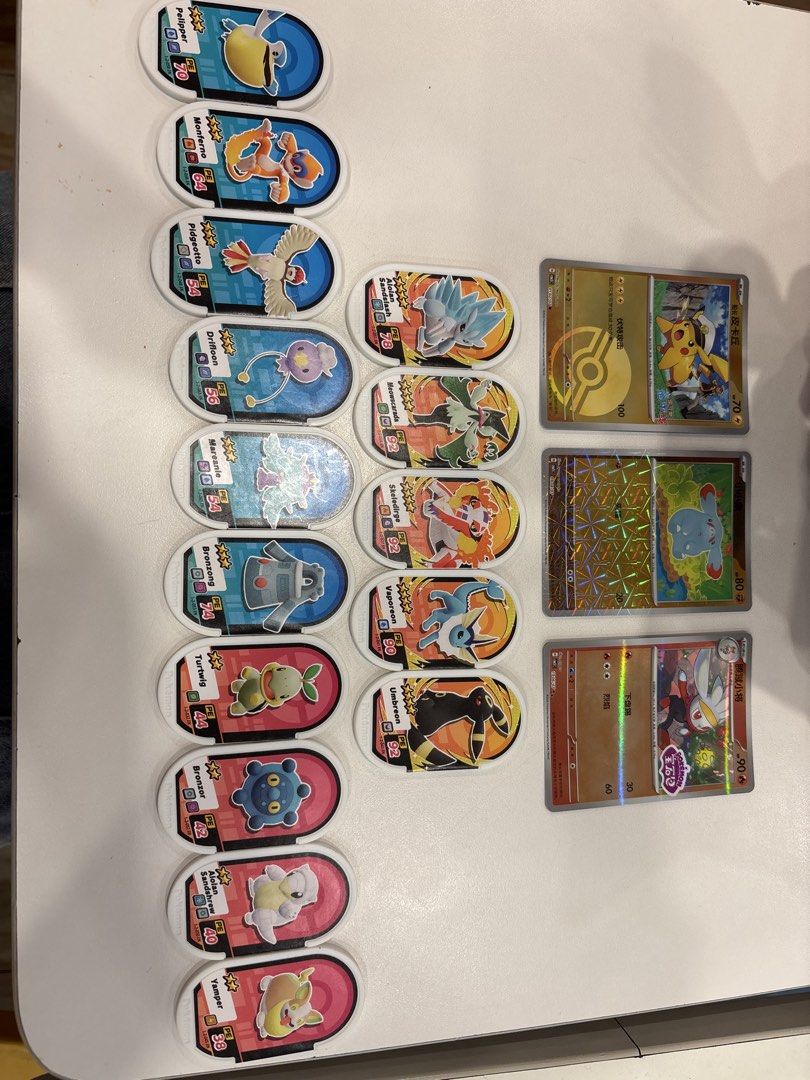 Pokemon Cards and Mezatags (Category: Raw Singles) located in Manila. Submitted by andreiambi74724 (Listing ID 1441049634, Image 1). Description: - Collection of Pokemon battle tokens and cards - Features popular Pokemon like Pikachu, Umbreon, and Vaporeon - Includes holographic cards for added rarity - Tokens display Pokemon characters and battle stats - Perfect for any Pokemon fan or collector.
