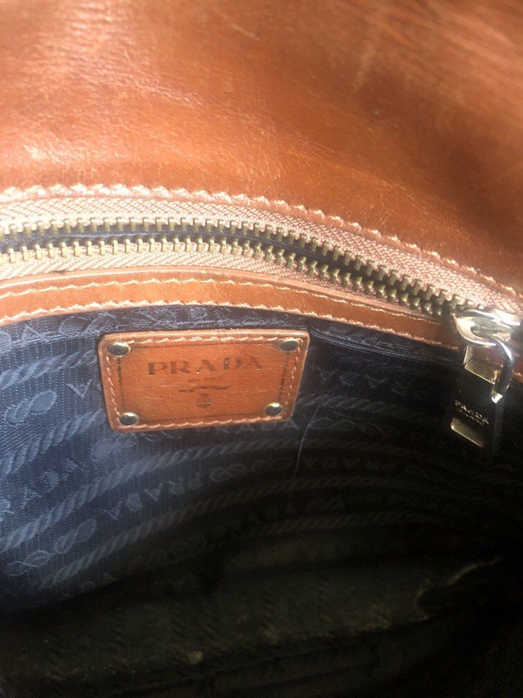 Prada Brown Leather Shoulder Bag (Category: Luxury Bags & Wallets) located in Tabuk. Submitted by qurst (Listing ID 1437812175, Image 3). Description: - Authentic Prada shoulder bag - Brown leather - Flap closure with Prada logo - Detachable shoulder strap - Chain strap.