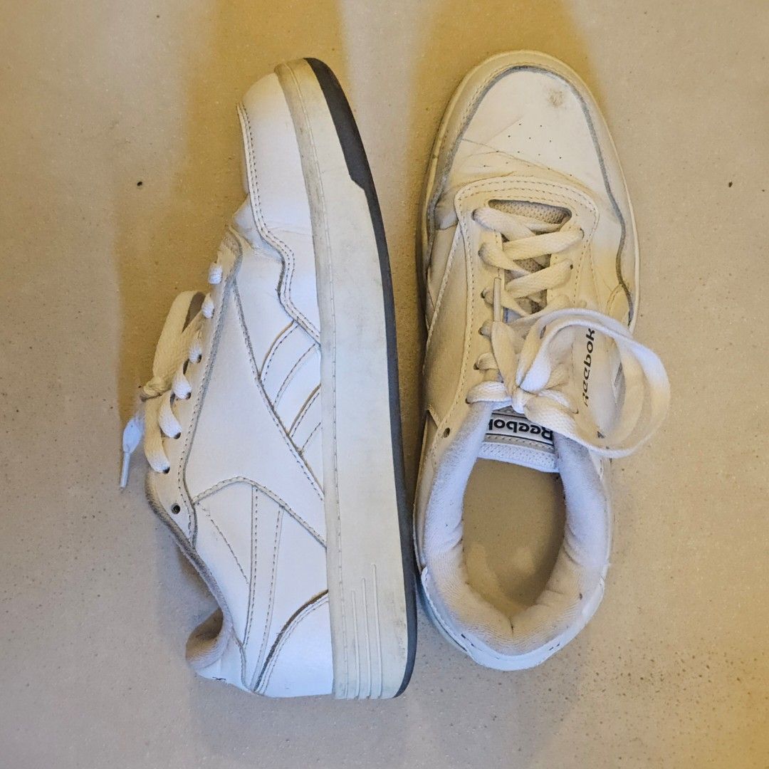 Reebok White Sneakers (Category: Sneakers) located in Silang. Submitted by monpeanut (Listing ID 1441025669, Image 2). Description: - Classic white Reebok low-top sneakers - White laces - Dark grey soles with Reebok branding - Visible scuffs and marks on white leather - Perfect for everyday casual wear.