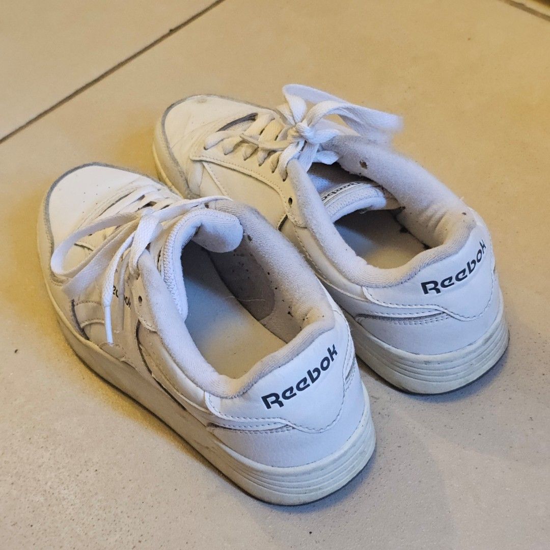 Reebok White Sneakers (Category: Sneakers) located in Silang. Submitted by monpeanut (Listing ID 1441025669, Image 3). Description: - Classic white Reebok low-top sneakers - White laces - Dark grey soles with Reebok branding - Visible scuffs and marks on white leather - Perfect for everyday casual wear.