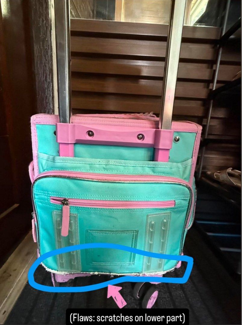 Sanrio Characters Trolley School Bag (Category: Backpacks) located in Pasig City. Submitted by trendsinstyle (Listing ID 1441070336, Image 3). Description: - Features adorable Sanrio characters: Kitty, Cinnamoroll, and My Melody. - Comes in cute pink and teal colors. - Equipped with wheels and a retractable handle for effortless carrying. - Please note: There are some scratches on the lower part of the bag. - Lunch box is not included. .