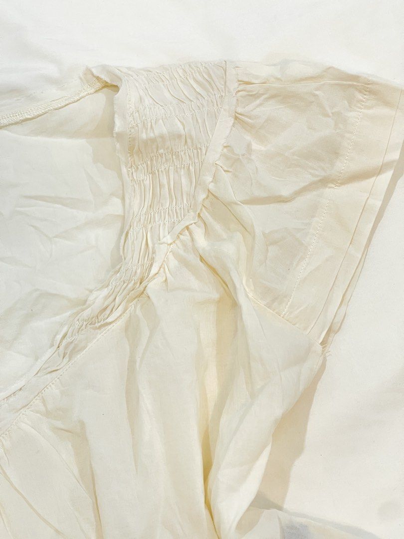SHEIN Cream Smocked V-Neck Flutter Sleeve Top (Category: Blouses) located in San Isidro. Submitted by kosfei (Listing ID 1441113862, Image 3). Description: fits S-M help me clean up my closet >< all items are pre-loved, most are unused or worn only once! visit my ig @riclauset for more info ^^ .