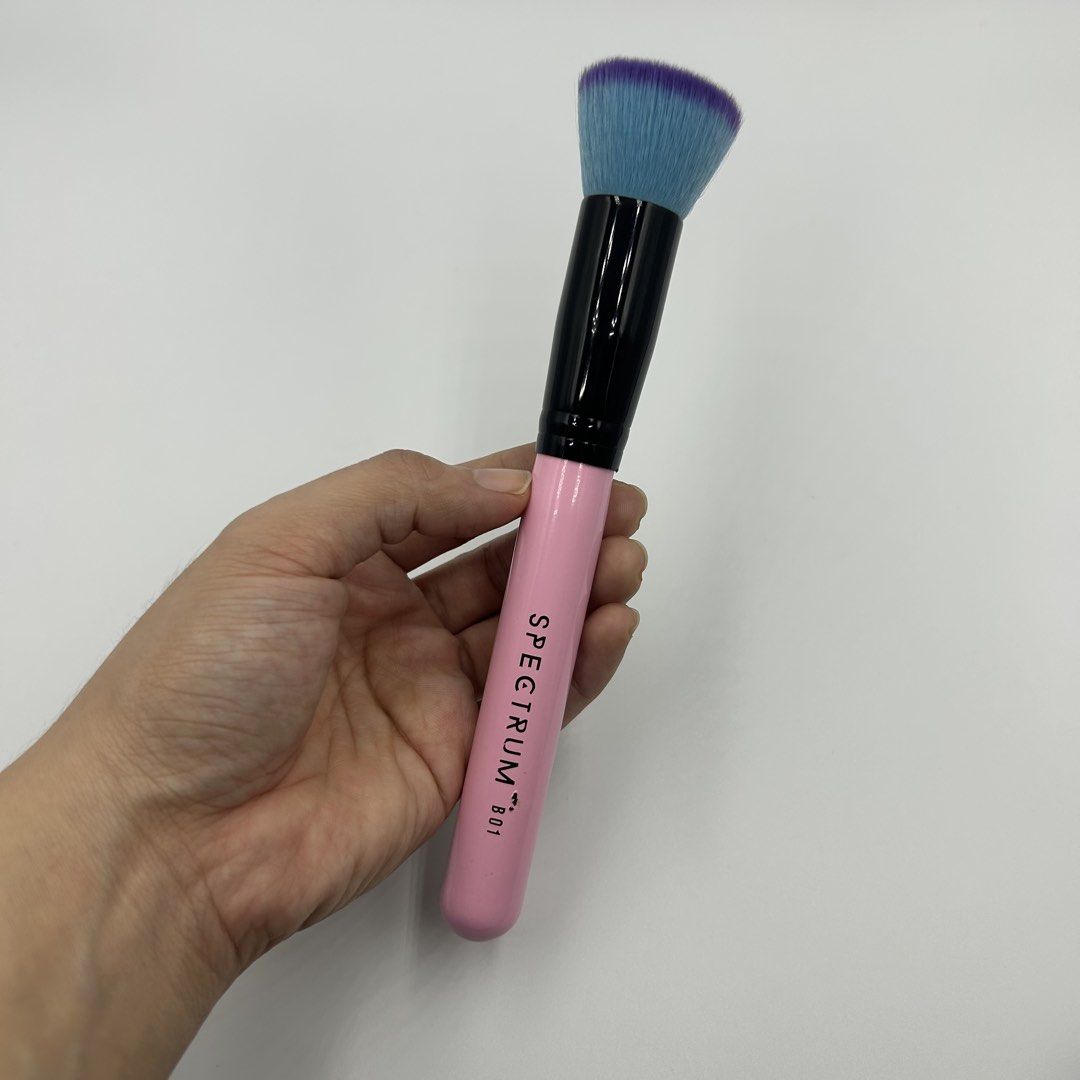 SPRECTRUM Pink B01 Flat Top Buffer Face Makeup Brush (Category: Makeup) located in Tanza. Submitted by shop_qrated (Listing ID 1440956022, Image 2). Description: SPRECTRUM Pink B01 Flat Top Buffer Face Makeup Brush. 100% authentic. New and never been used. Stored only. This is a Spectrum Collections B01 Flat Top Buffer Brush featuring a signature pink handle and blue bristles with purple tips. Ultra-smooth vegan bristles for seamless blending wit