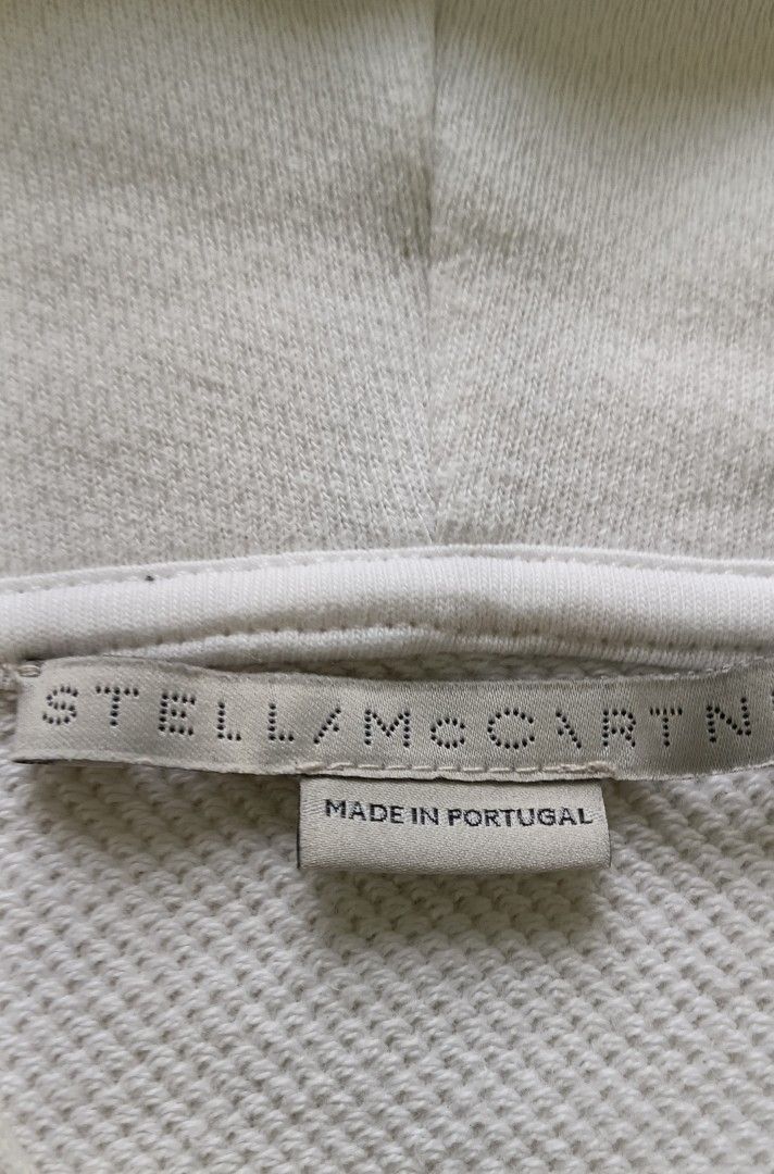 Stella McCartney 2001 Hoodie White (Category: Coats, Jackets and Outerwear) located in Cebu City. Submitted by mcmapio (Listing ID 1441049821, Image 2). Description: - White Stella McCartney hoodie - Cropped style - Drawstring hood - Features 'STELLA MCCARTNEY 2001.' text on the front - Made in Portugal - Size 38.