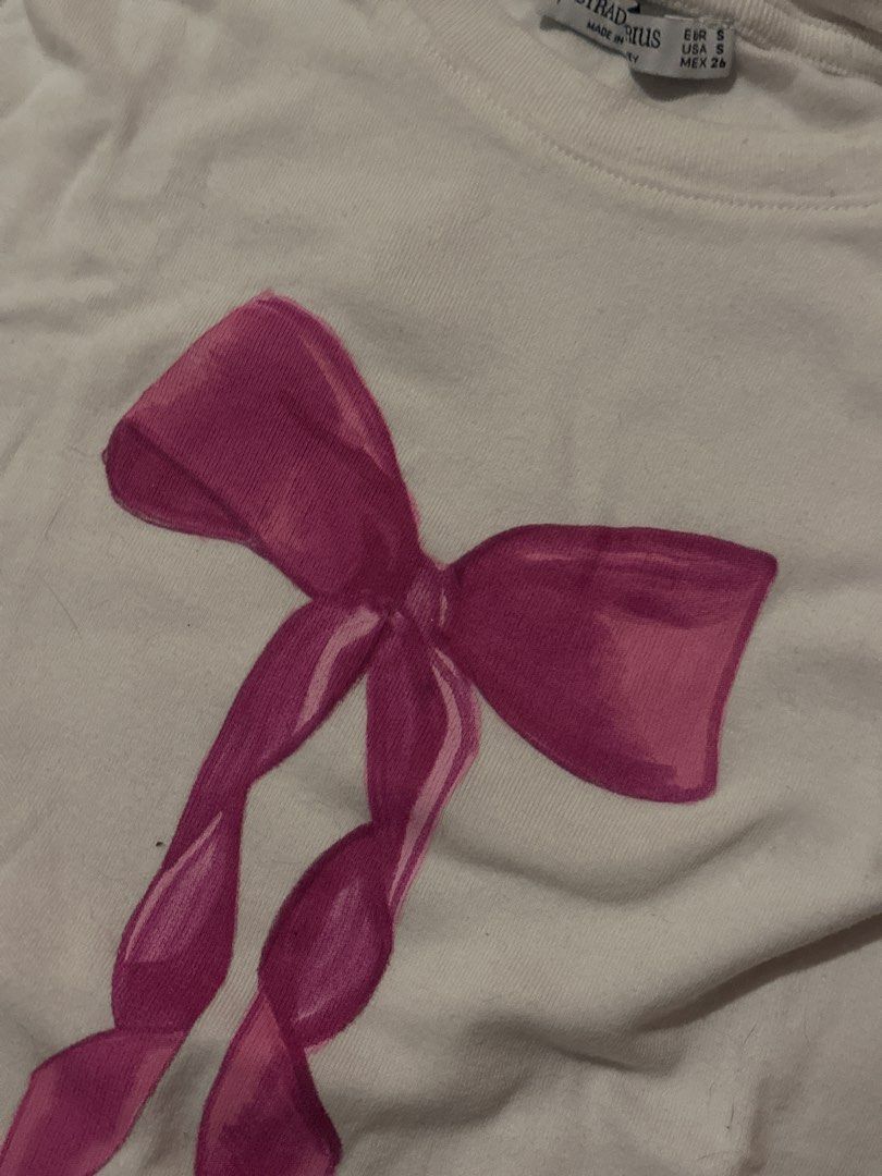 Stradivarius Pink Bow Baby Tee (Category: Shirts) located in Manila. Submitted by _____t1mmy (Listing ID 1441122163, Image 3). Description: - White t-shirt with a cute pink bow graphic print - Short sleeves, crew neck - Size S - Perfect for casual everyday wear - Negotiable Helping tags: miu the label blackbough carino the brand halohalo zara lululemon realisation par glossier araw rhode peptide gvn aztrid owala gentle monster miu miu.