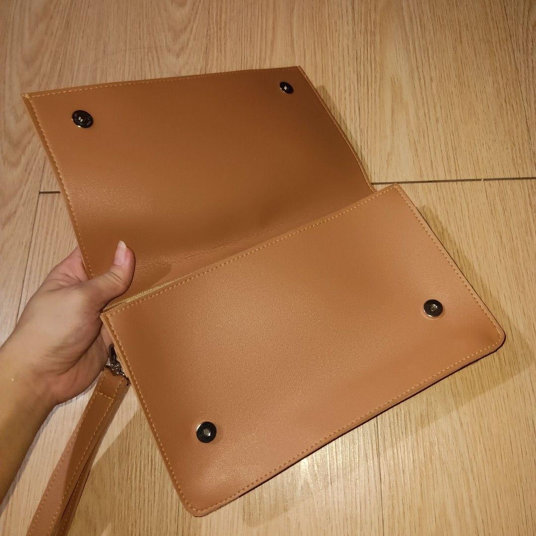STRAIGHTFORWARD Vegan Leather Clutch Bag (Category: Clutches) located in Taguig. Submitted by ncomn (Listing ID 1441088968, Image 2). Description: - Vegan leather clutch with removal wrist strap - Secure magnetic closure inside - No scratches, slight deformed, never used, like new.
