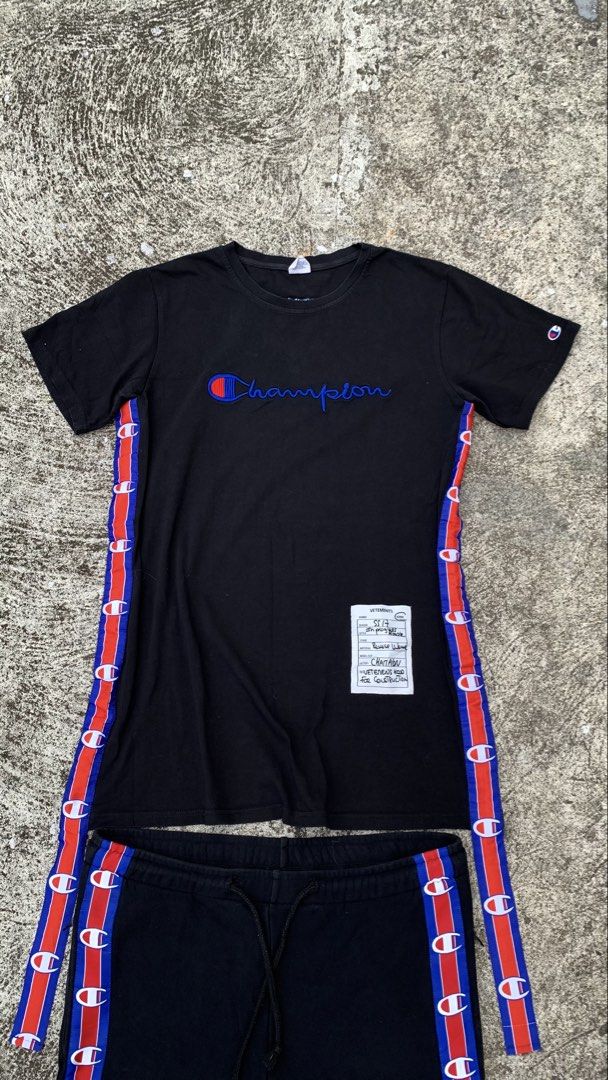 Vetements x Champion (Category: Sets & Coordinates) located in Jamindan. Submitted by darinville30528 (Listing ID 1441051291, Image 2). Description: - Dimes Tee Shirt: L31 x W22 - Dimes Pants: W34-36 x L39.5 - Dm📩 For More Details - Vetements x Champion black tracksuit set - Iconic Champion logo on t-shirt - Vetements Automne-Hiver 2018 print on back of t-shirt - Tape detailing down the sides of both top and bottoms - Ideal for casual wear or at