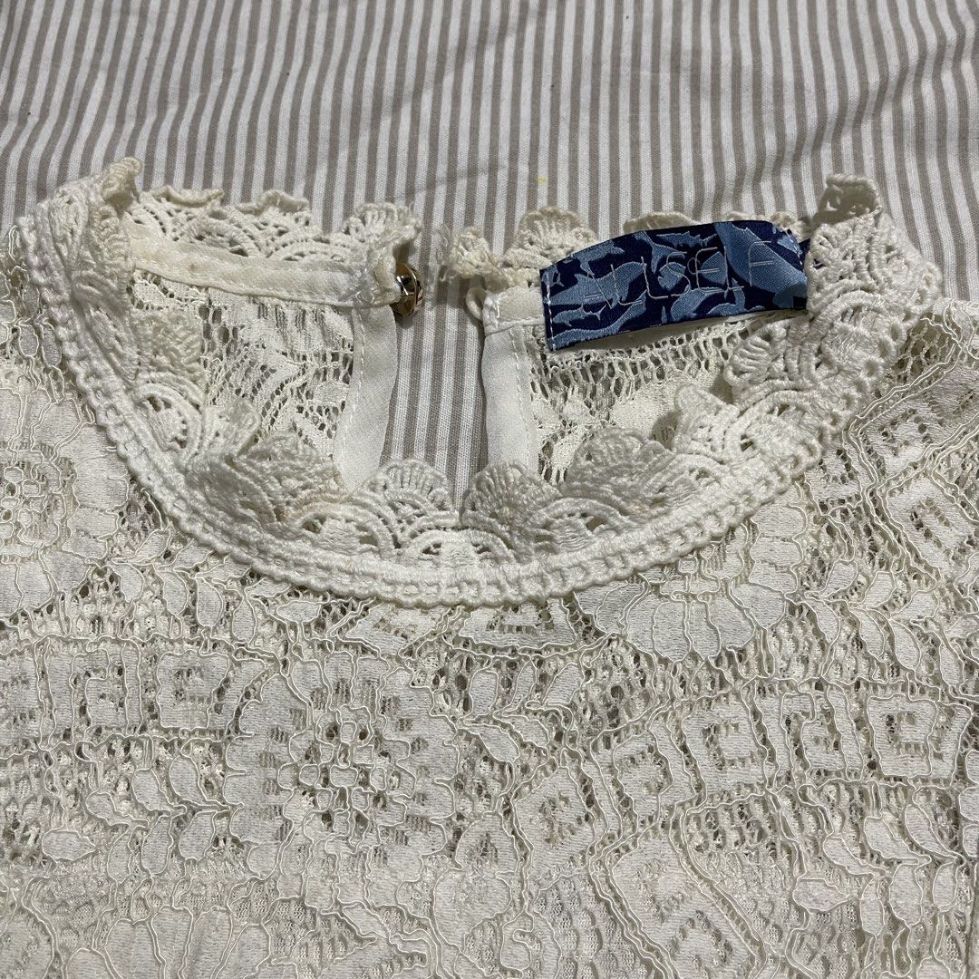 White Lace High Neck Sleeveless Top (Category: Sleeveless) located in Binmaley. Submitted by castilloar83486 (Listing ID 1441092893, Image 2). Description: PRICE CAN BE NEGOTIATED - Chic white lace top - Elegant mock neck design - Sleeveless with lace trim - Detailed floral and geometric lace pattern - Convenient button closure at the back - Versatile for dressing up or down Loc: Pangasinan J&T Express MOP: Gcash only.