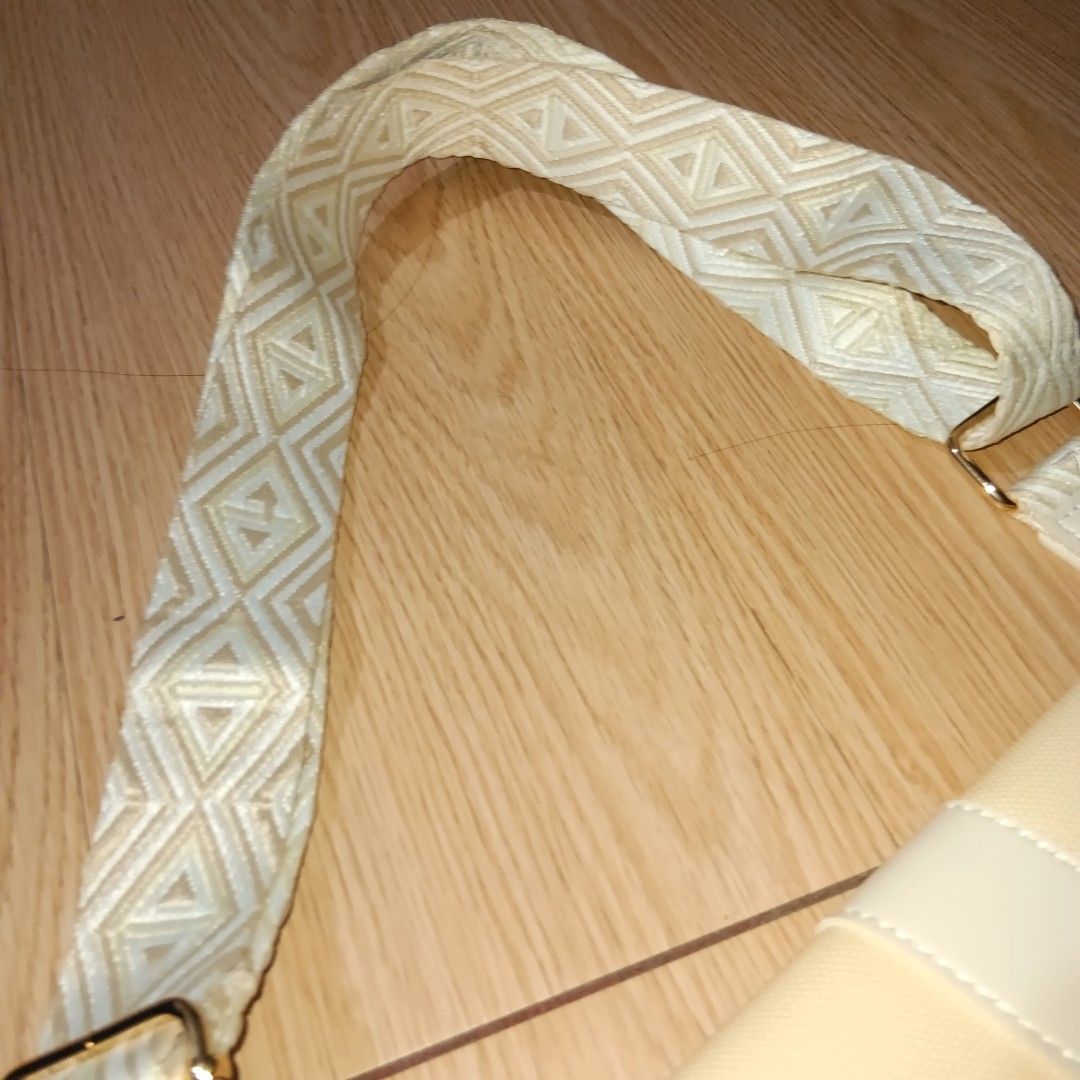 White Saddle Bag with Patterned Strap (Category: Shoulder Bags) located in Taguig. Submitted by ncomn (Listing ID 1441093293, Image 2). Description: - Cute saddle white and cream with textured strap - Bag from Parisian - New, never worn .