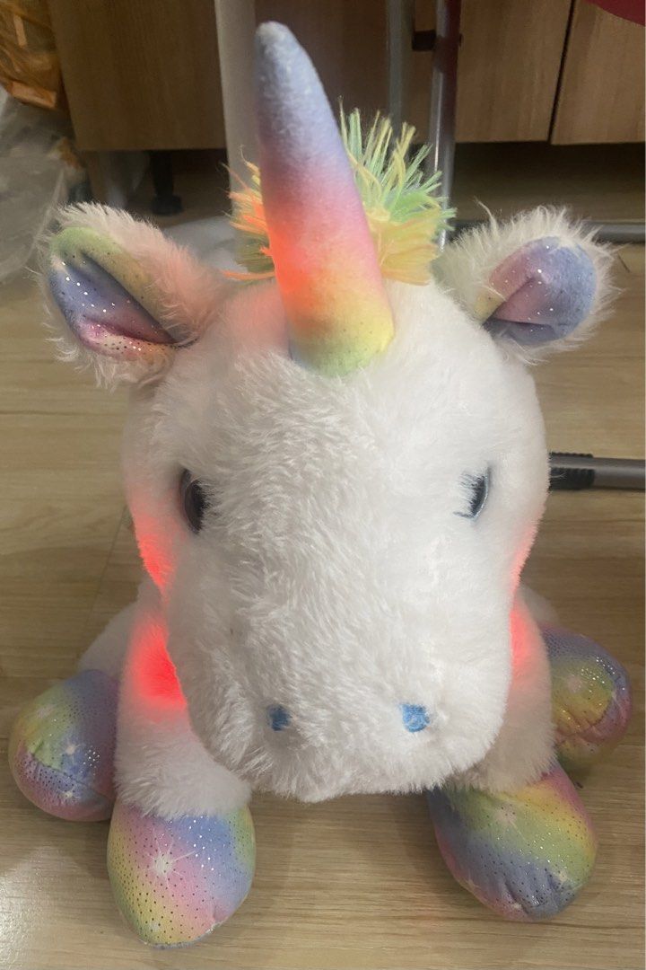 White Unicorn with Rainbow Lights (Category: Plushies & Soft Toys) located in Makati City. Submitted by ann.declutter (Listing ID 1441022578, Image 2). Description: - When you press the button on the right front paw, the unicorn lights up into rainbow colors - Adorable white unicorn plush toy. - Features a rainbow-colored horn and ears. - Glitter accents add a magical touch. - Rainbow and star pattern on hooves. - Soft and cuddly, ideal for play 