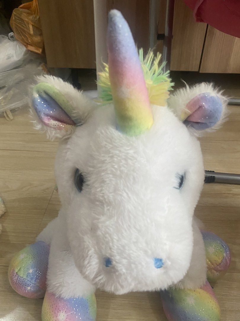 White Unicorn with Rainbow Lights (Category: Plushies & Soft Toys) located in Makati City. Submitted by ann.declutter (Listing ID 1441022578, Image 1). Description: - When you press the button on the right front paw, the unicorn lights up into rainbow colors - Adorable white unicorn plush toy. - Features a rainbow-colored horn and ears. - Glitter accents add a magical touch. - Rainbow and star pattern on hooves. - Soft and cuddly, ideal for play 