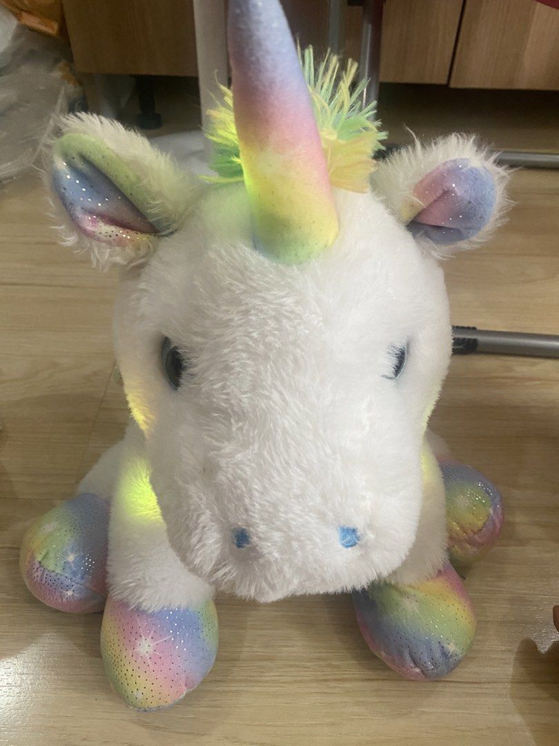 White Unicorn with Rainbow Lights (Category: Plushies & Soft Toys) located in Makati City. Submitted by ann.declutter (Listing ID 1441022578, Image 3). Description: - When you press the button on the right front paw, the unicorn lights up into rainbow colors - Adorable white unicorn plush toy. - Features a rainbow-colored horn and ears. - Glitter accents add a magical touch. - Rainbow and star pattern on hooves. - Soft and cuddly, ideal for play 