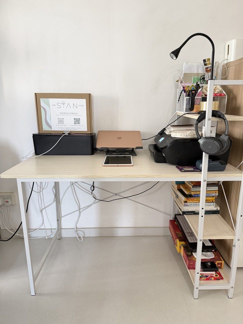 Study Table| Office table (Category: Tables & Sets) located in Singapore. Submitted by winter_mountains (Listing ID 1440975454, Image 1). Description: H-70cm L-120 W-60 Height of side shelves- 115cm - Complete desk setup for your home office or study. - Light wood desk with white metal legs. - Matching shelving unit. - Includes: Printer, laptop, tablet, books, headphones, office supplies. - All items neatly organized and ready to go..