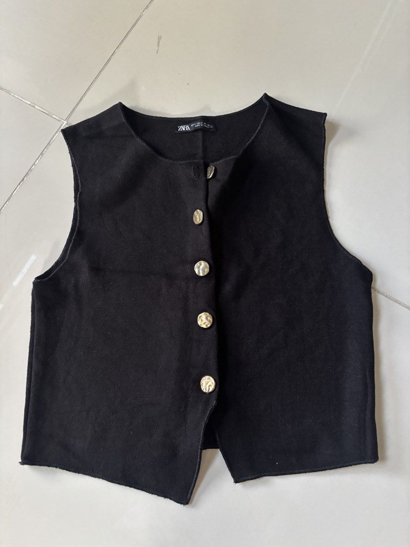 Zara Black Button-Up Sleeveless Vest (Category: Sleeveless) located in Manila. Submitted by starapple24_ (Listing ID 1441052728, Image 1). Description: only worn twice ! - Zara black vest - Size S (fits like S) - Gold-tone buttons down the front - Sleeveless design - Made in Turkey - Great for layering.