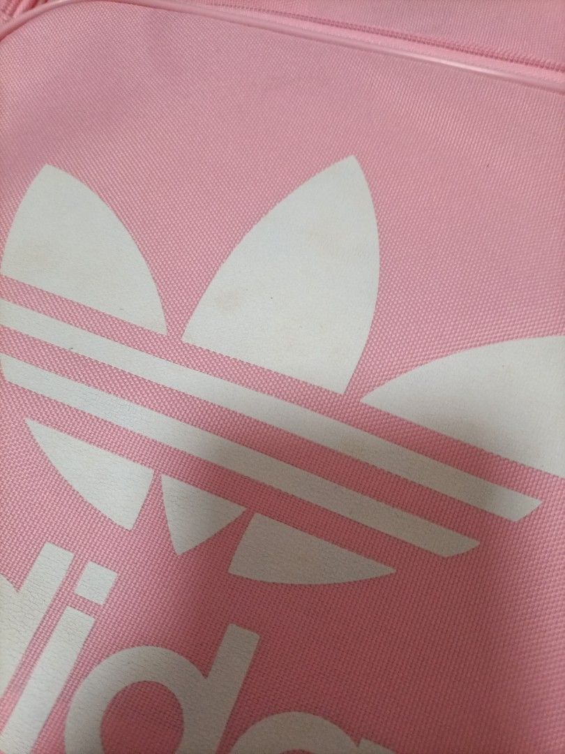 Authentic Adidas Pink Backpack (Category: Backpacks) located in Singapore. Submitted by iris_rae (Listing ID 1436046120, Image 3). Description: - Pink Adidas backpack - Features the Adidas trefoil logo - Adjustable shoulder straps - Top handle - Suitable for everyday use - Minor yellowing marks on logo comes with free pink doraemon bag charm Abit of yellowing on the doraemon.