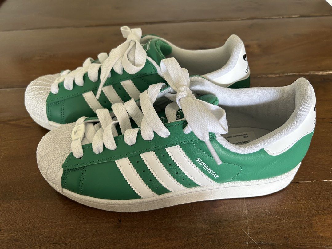 Adidas Superstar Green White Sneakers US9.5/UK9 (Category: Sneakers) located in Taguig. Submitted by mdinvestbuildtrade (Listing ID 1435951791, Image 1). Description: Adidas Lifestyle Superstar II Shoes Unisex Green JI3076 (Boston Celtics inspired) Bought in Bangkok and realized it’s half size smaller - Adidas Superstar sneakers - Green and white colorway - Boston Celtics inspired - Classic three stripes design - Size: UK 9 / US 9.5 - Unworn cond