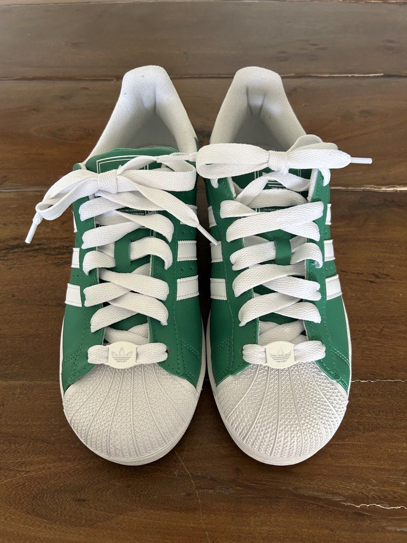 Adidas Superstar Green White Sneakers US9.5/UK9 (Category: Sneakers) located in Taguig. Submitted by mdinvestbuildtrade (Listing ID 1435951791, Image 2). Description: Adidas Lifestyle Superstar II Shoes Unisex Green JI3076 (Boston Celtics inspired) Bought in Bangkok and realized it’s half size smaller - Adidas Superstar sneakers - Green and white colorway - Boston Celtics inspired - Classic three stripes design - Size: UK 9 / US 9.5 - Unworn cond