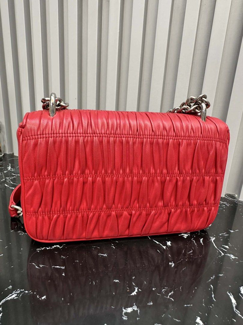 💯AUTHENTIC PRADA RED GAUFRE BAG (Category: Luxury Bags & Wallets) located in Iligan City. Submitted by monfinds (Listing ID 1435780666, Image 3). Description: Personal preloved Rank AB With entrupy cert, in silver hardware, very slight issue light oxidation sa likod check niyo sa photos di naman halata at visible pero declared ko parin kasi honest ako😊, still rank AB for me no rubs still excellent condition🫶 Rfs preferred bigger bag mommy na k