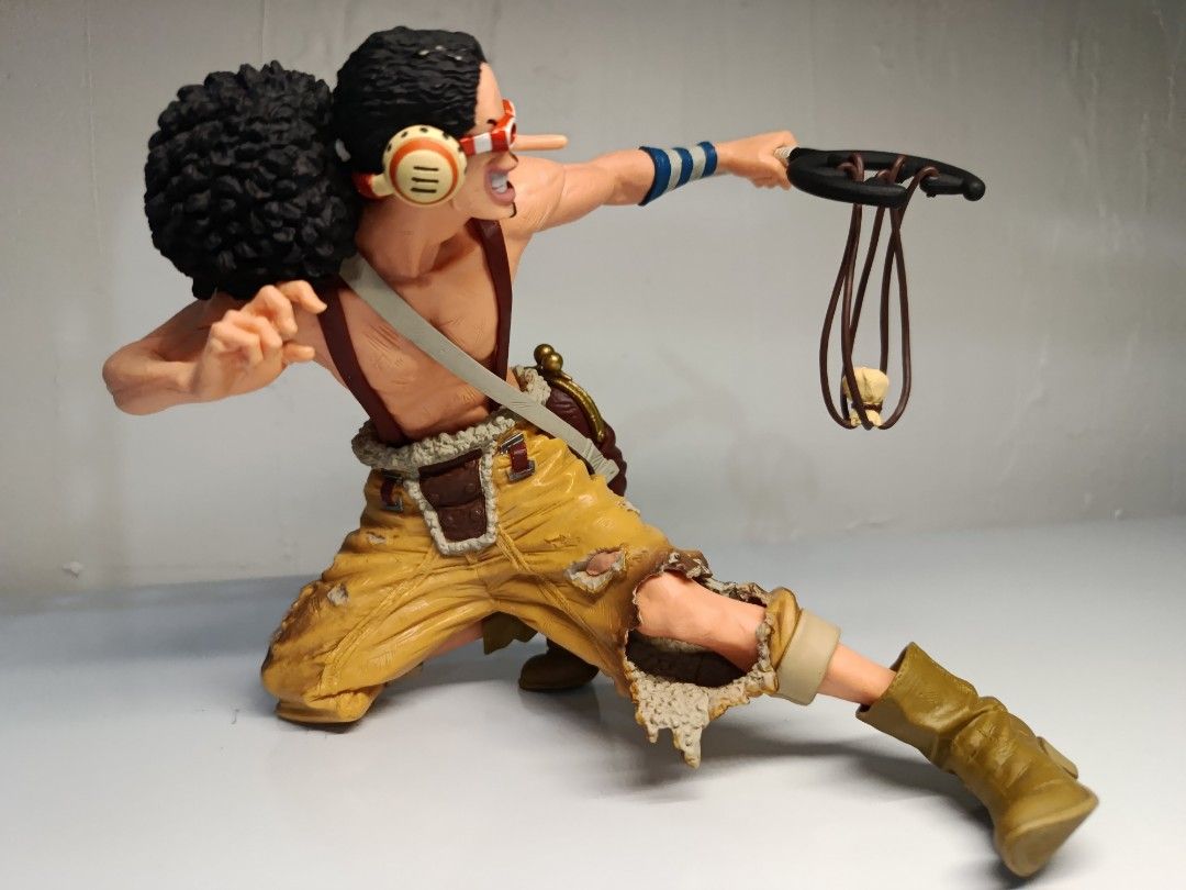 Banpresto One Piece King of Artist Usopp (Loose) (Category: Toys & Games) located in Davao. Submitted by joieful_collectibles (Listing ID 1436082072, Image 2). Description: Banpresto One Piece King of Artist Usopp figure. (Loose) - Usopp figure from One Piece - Detailed sculpting and vibrant colors - Dynamic pose with slingshot - Includes signature goggles, afro hairstyle, and outfit - This PVC figure stands approximately 14 cm (5.46 inches) tall