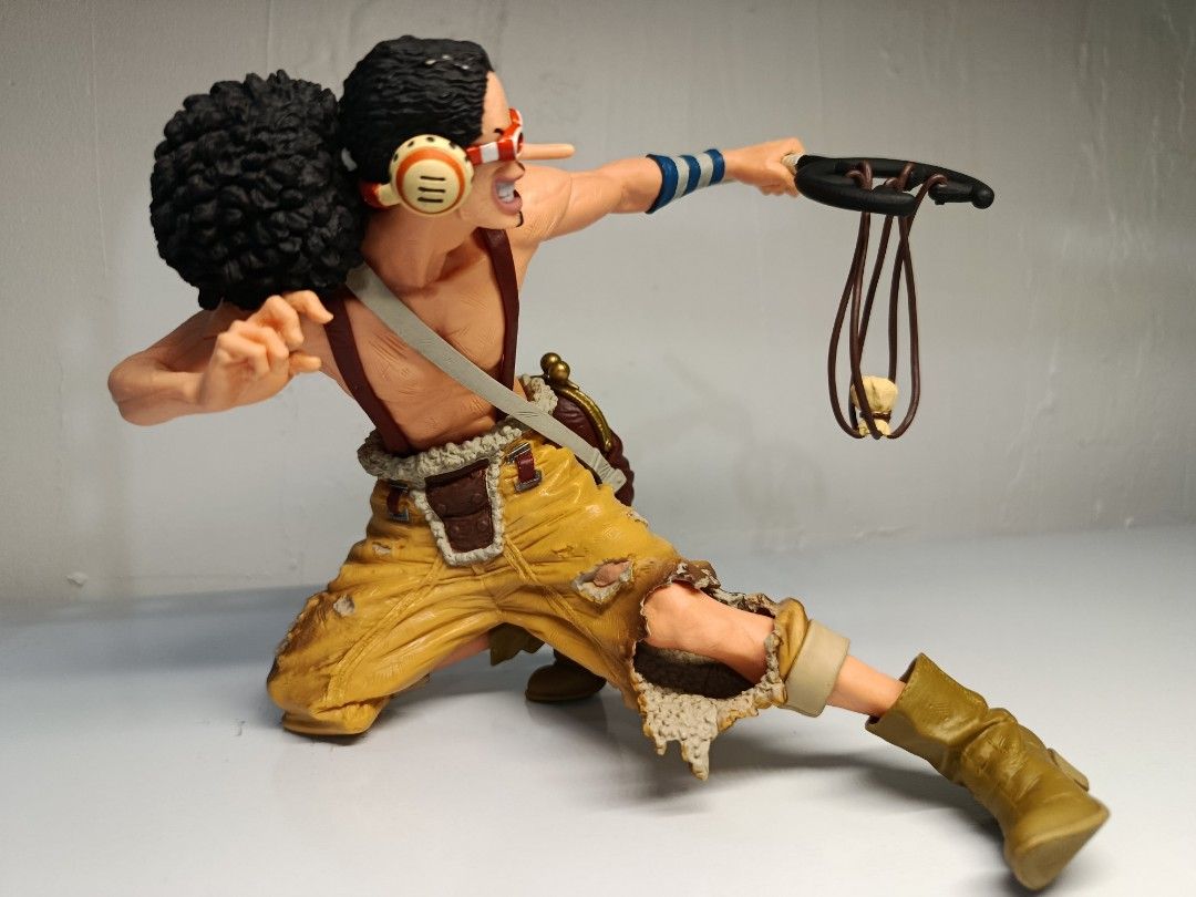 Banpresto One Piece King of Artist Usopp (Loose) (Category: Toys & Games) located in Davao. Submitted by joieful_collectibles (Listing ID 1436082072, Image 3). Description: Banpresto One Piece King of Artist Usopp figure. (Loose) - Usopp figure from One Piece - Detailed sculpting and vibrant colors - Dynamic pose with slingshot - Includes signature goggles, afro hairstyle, and outfit - This PVC figure stands approximately 14 cm (5.46 inches) tall
