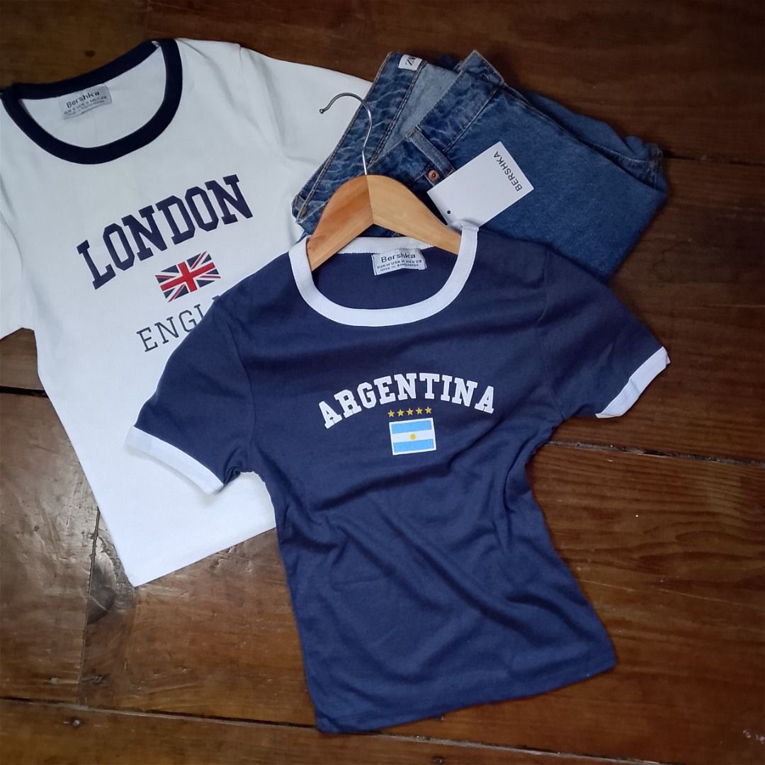 Bershka Graphic T-shirts (Category: Shirts) located in Baguio. Submitted by kezsells (Listing ID 1436009552, Image 2). Description: - Bershka graphic t-shirts - Featuring country designs: London, Spain, Scotland, Argentina, Greece, USA - Contrasting collar and sleeve colors - Made of soft, comfortable material - Perfect for casual wear.
