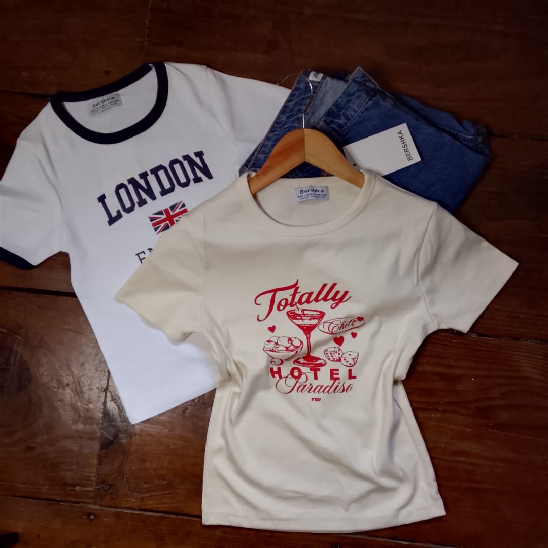 Bershka Graphic T-shirts (Category: Shirts) located in Baguio. Submitted by kezsells (Listing ID 1436009552, Image 1). Description: - Bershka graphic t-shirts - Featuring country designs: London, Spain, Scotland, Argentina, Greece, USA - Contrasting collar and sleeve colors - Made of soft, comfortable material - Perfect for casual wear.