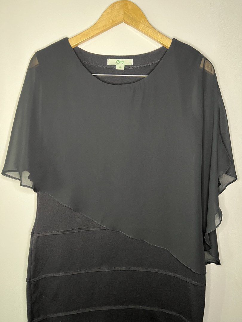 Black Chiffon Poncho Dress (Category: Dresses) located in Quezon City. Submitted by pcera (Listing ID 1436048796, Image 2). Description: - Curvy black dress - Layered design with sheer overlay - Round neckline - Short sleeves - Knee-length - Size: XL - Ideal for formal events and nights out.