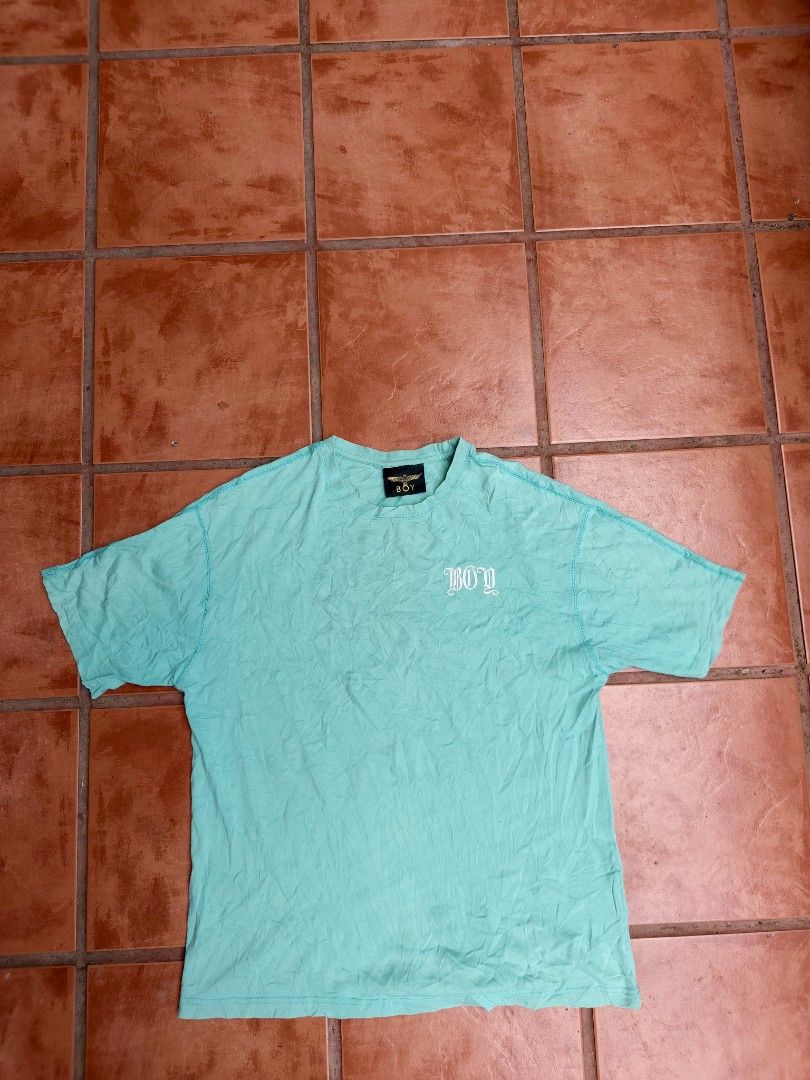 Boy London Eagle Graphic T-shirt (Category: Tshirts & Polo Shirts ) located in Manila. Submitted by lesterpogs30 (Listing ID 1436074869, Image 1). Description: - Authentic Boy London T-shirt - Size: M - Color: Light Teal - Features an eagle graphic on the back - Boy London logo on the front - Crew neck and short sleeves.