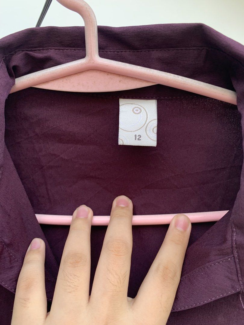 Burgundy Button-Down Blouse Size 12 (Category: Blouses) located in Cavite. Submitted by jetsyfinds (Listing ID 1436057980, Image 3). Description: - Burgundy button-down blouse - Size: 12 - Features: Collared neckline, three-quarter sleeves, button-up front - Solid color, smooth fabric - Versatile: Suitable for casual and semi-formal occasions.