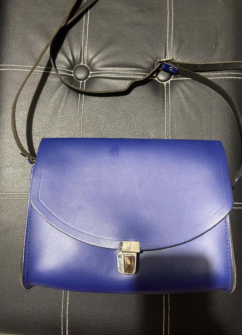 Cambridge Satchel Cobalt Blue Crossbody Bag (Category: Cross-body Bags) located in Cavite. Submitted by jesusahec44856 (Listing ID 1436020197, Image 1). Description: - Cobalt blue Cambridge Satchel crossbody bag - Flap closure with silver clasp - Adjustable long strap - Black interior - Cambridge Satchel logo embossed on the back - Brand name engraved on the buckle.