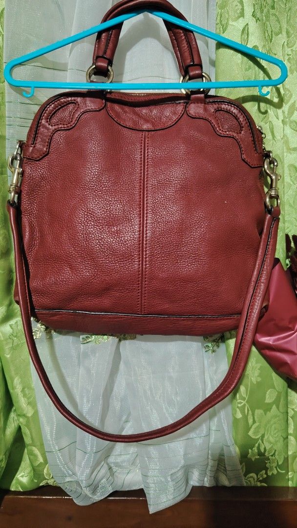 Cartier Red Leather Handbag (Category: Luxury Bags & Wallets) located in Santa Rosa. Submitted by RRRR0520 (Listing ID 1435922349, Image 2). Description: - Red leather handbag - Top handle and detachable shoulder strap - Cartier logo embossed on front - Cartier logo charm - Zip closure - Metal hardware SIGN OF USED PLEASE CHECK PHOTOS SELF AUTHENTICATE .