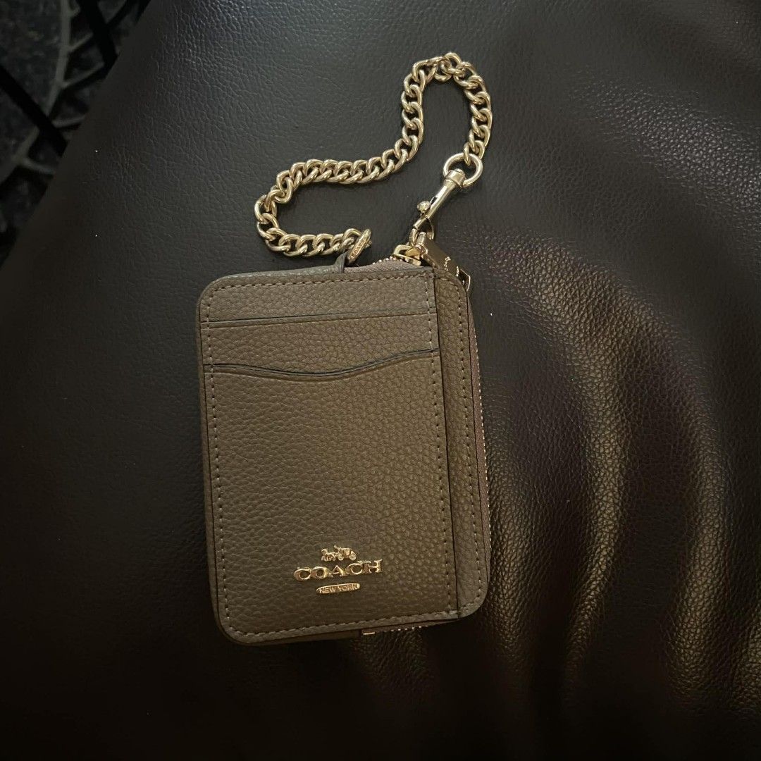 Coach Card Case with Chain (Category: Luxury Bags & Wallets) located in Manila. Submitted by johnsebast21651 (Listing ID 1435991826, Image 1). Description: - Coach card case - Zip-around closure - Clear ID window - Gold-tone chain and hardware - Multiple card slots - Small zippered compartment - Textured leather exterior - Coach logo detail - YKK zip .