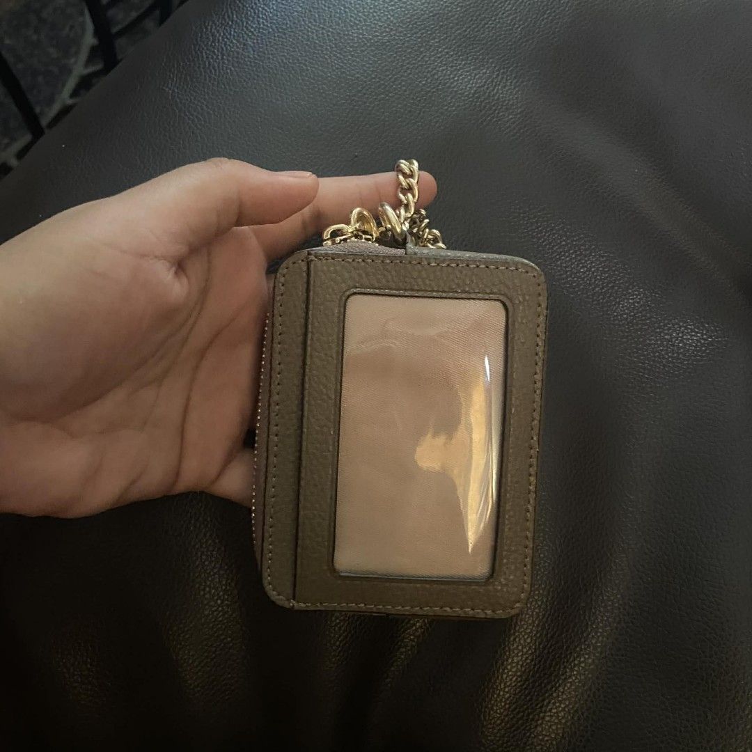 Coach Card Case with Chain (Category: Luxury Bags & Wallets) located in Manila. Submitted by johnsebast21651 (Listing ID 1435991826, Image 2). Description: - Coach card case - Zip-around closure - Clear ID window - Gold-tone chain and hardware - Multiple card slots - Small zippered compartment - Textured leather exterior - Coach logo detail - YKK zip .