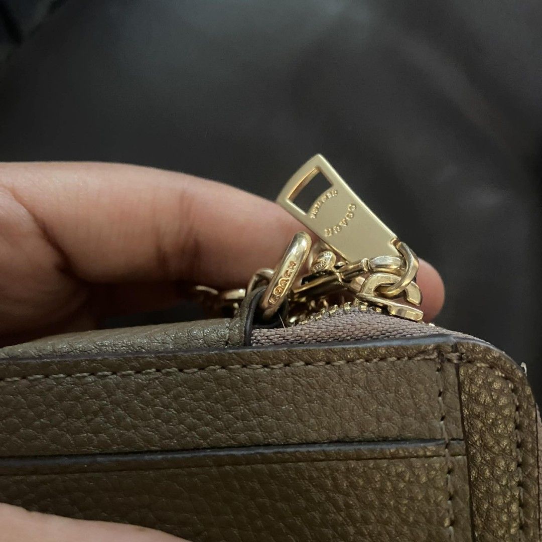 Coach Card Case with Chain (Category: Luxury Bags & Wallets) located in Manila. Submitted by johnsebast21651 (Listing ID 1435991826, Image 3). Description: - Coach card case - Zip-around closure - Clear ID window - Gold-tone chain and hardware - Multiple card slots - Small zippered compartment - Textured leather exterior - Coach logo detail - YKK zip .