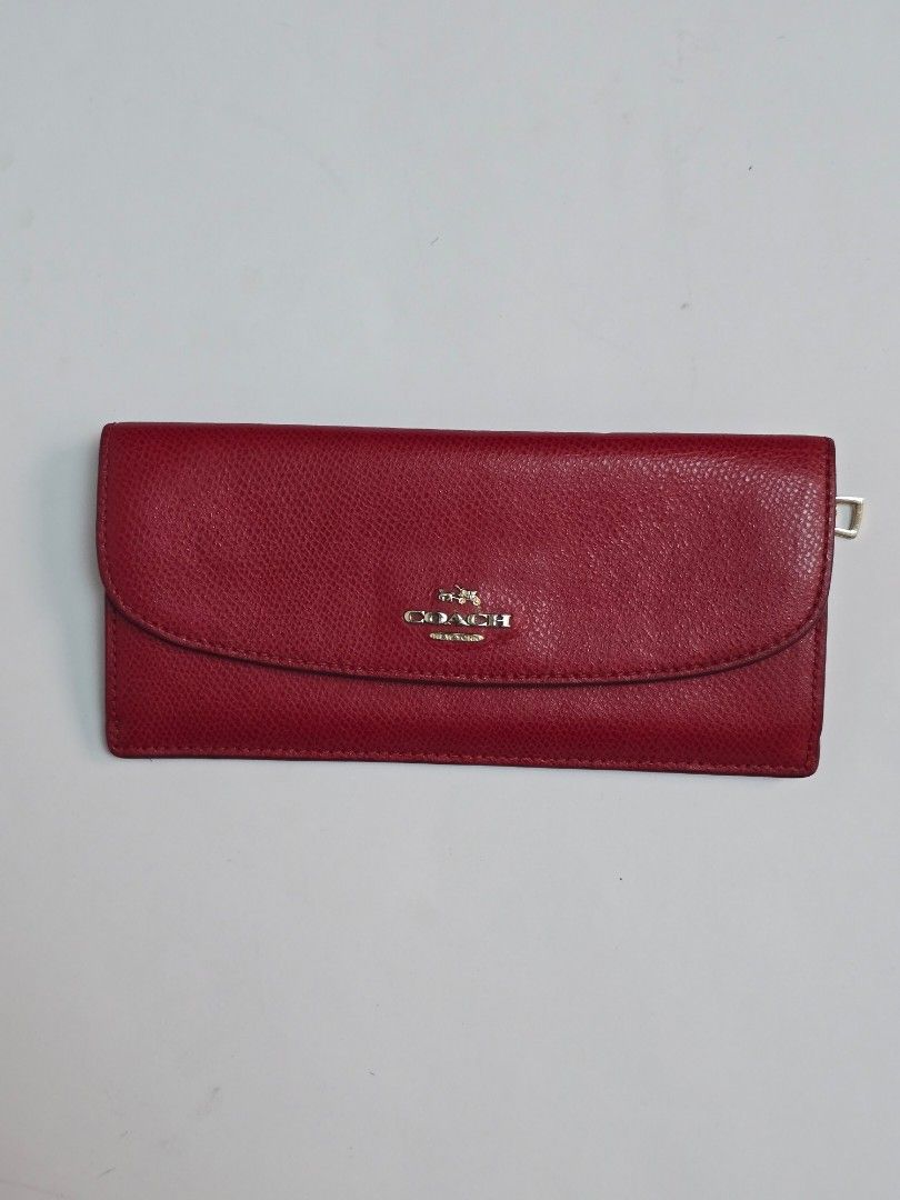Coach Red Long Wallet (Category: Luxury Bags & Wallets) located in Quezon City. Submitted by julvinzon (Listing ID 1435994744, Image 1). Description: Coach Red Envelope Wallet Color: Red Condition: 8/10 imo Hardwares needs a bit of cleaning but leather is still soft 📍 QC Don't hesitate to make an offer🙏 *color may differ from actual due to lighting.