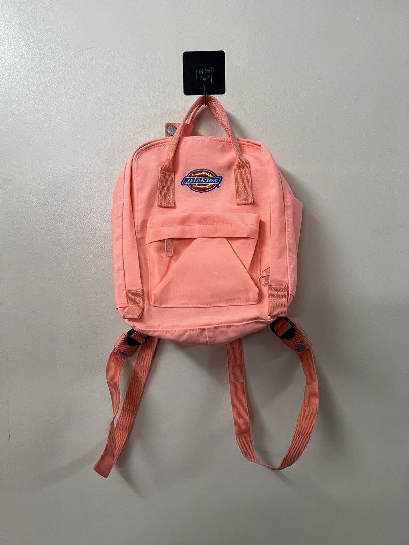 Dickies Backpack - Peach (Category: Backpacks) located in Manila. Submitted by herbolingo55834 (Listing ID 1435968596, Image 3). Description: - Dickies backpack in a lovely peach color. - Features a front pocket. - Adjustable straps for a comfortable fit. - Includes a top handle for easy carrying. - Durable material for everyday use. - Interior with Dickies logo patch. - Stylish and practical design..