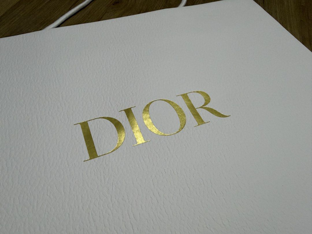 Dior Shopping Bag (Landscape) (Category: Craft Supplies & Tools) located in Valenzuela. Submitted by minami34 (Listing ID 1436030547, Image 3). Description: - Authentic Dior shopping bag - Features the Dior logo in gold - White textured paper - White rope handles - Gold bee interior logo - Perfect for gifting or collecting Dimensions: (L- 42.1cm x W- 30.1cm x D - 13.2cm) Reason for selling: Declutter Note: Shipping Fee (SF) still not included. Mo