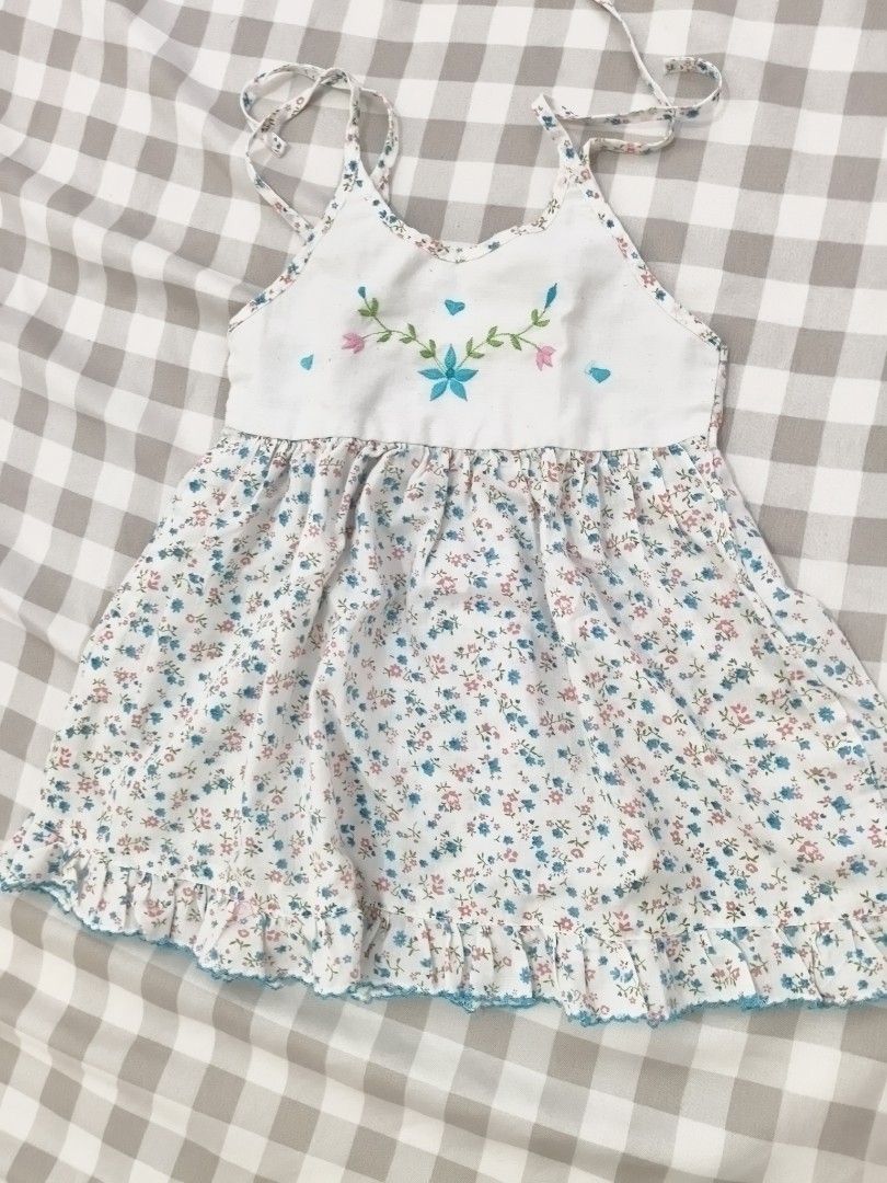 Floral Embroidered Dress (Category: Babies & Kids Fashion) located in Manila. Submitted by meng81014 (Listing ID 1436023801, Image 1). Description: - Adorable floral dress for little girls. - White bodice with embroidered flowers. - Flowing skirt with blue and pink floral pattern. - Delicate straps and ruffled hemline. - Perfect for special occasions or everyday wear..