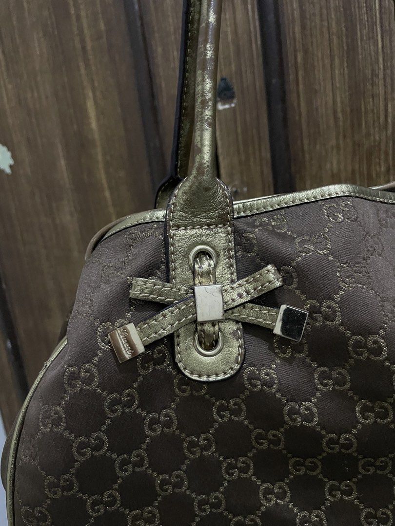 Gucci Brown and Gold Handbag (Category: Luxury Bags & Wallets) located in Manila. Submitted by triciabugtong (Listing ID 1436047977, Image 2). Description: - Authentic Gucci handbag - Iconic GG monogram pattern - Brown fabric body - Gold-colored accents - Classic tote style - Zipper closure - Interior Gucci logo - Serial number: "161718".
