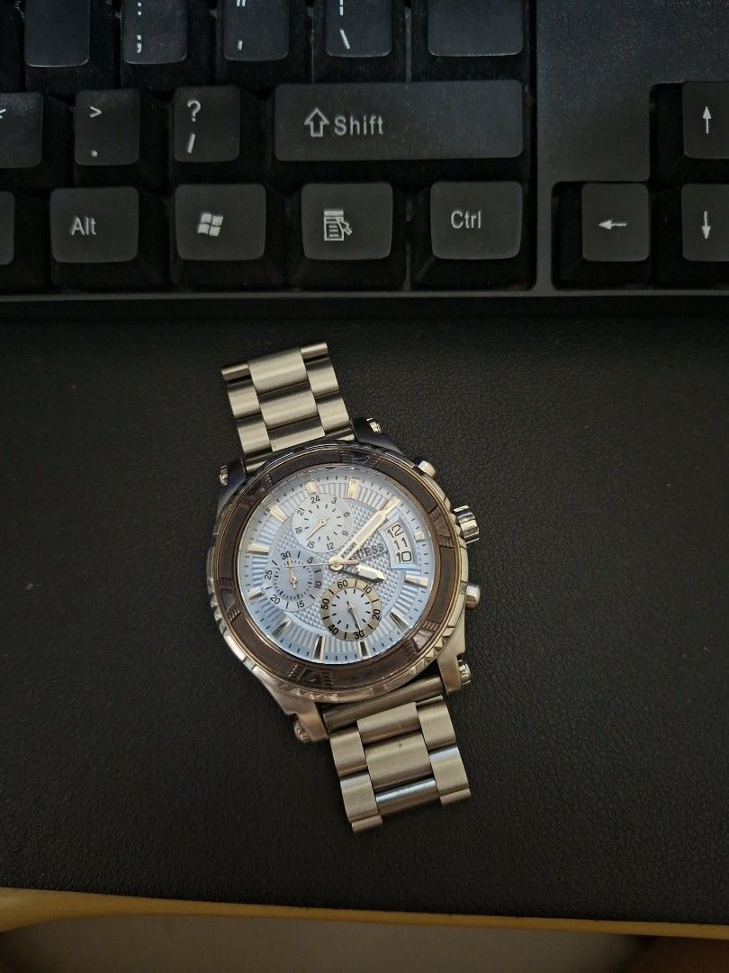 Guess Chronograph Watch (Category: Men's Watches) located in Pasig City. Submitted by jax_declutters (Listing ID 1435960330, Image 3). Description: -Guess watch - Silver-tone stainless steel bracelet and case - Light blue dial - Chronograph sub-dials - Date display - Brown bezel - Clasp closure.