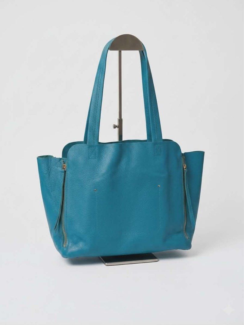Hiroshima Handbag (Category: Luxury Bags & Wallets) located in Cavite. Submitted by bags_unltd143 (Listing ID 1435978900, Image 2). Description: Handbag features a vibrant turquoise exterior and a patterned interior lining. The brand name "Hiroshima" is visible on a leather tag inside the bag. It has a gold zipper. The interior lining has a floral pattern..